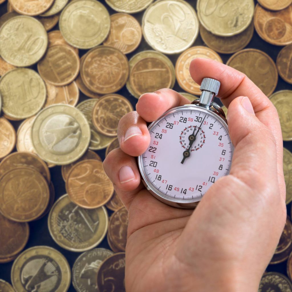 Imagen de monedas y un reloj que hace referencia al tiempo y la organización.